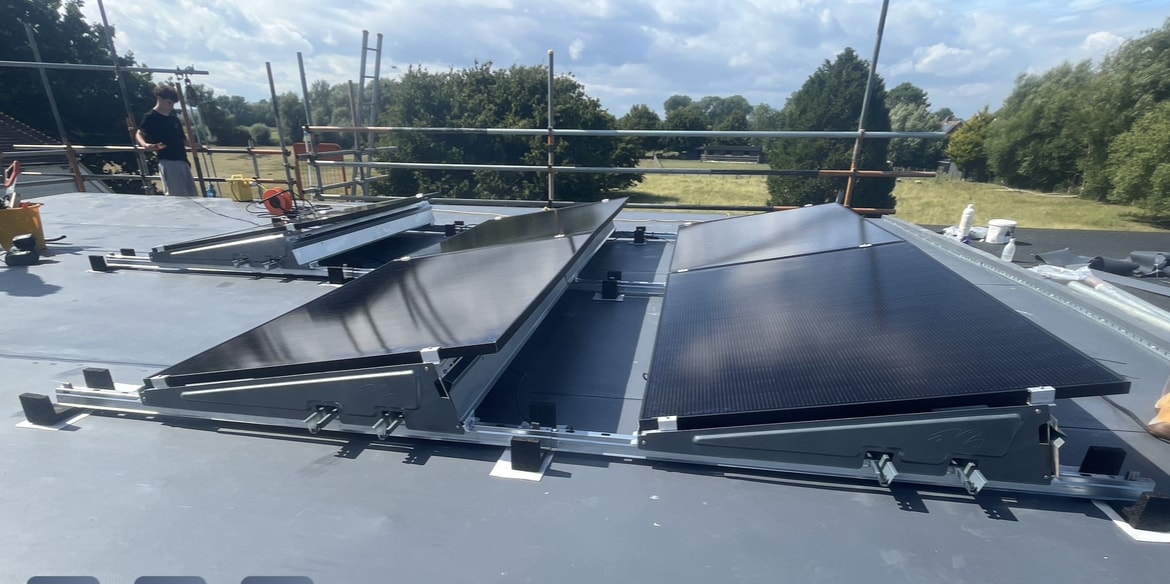 Solar panel array on flat roof with skylights