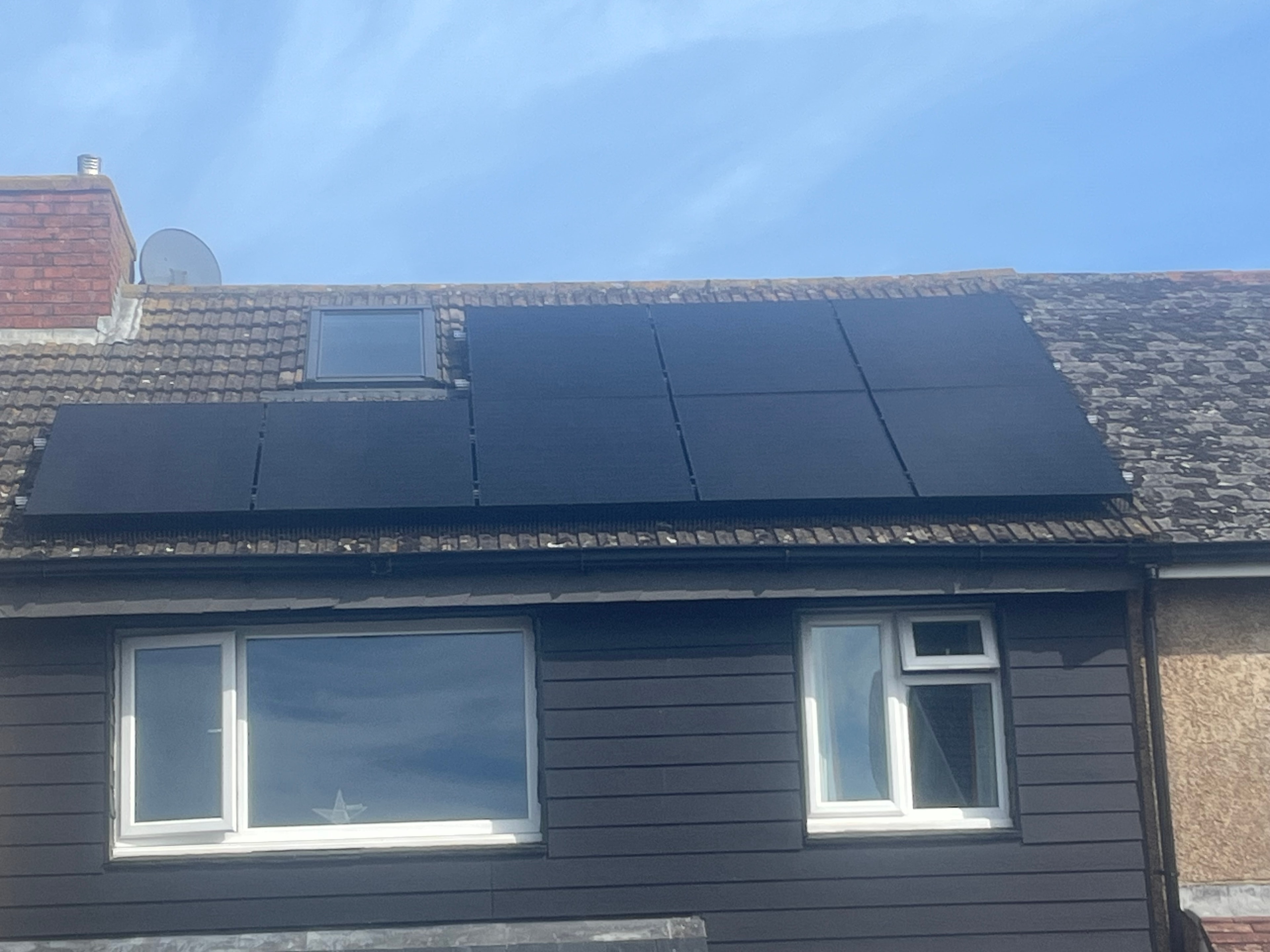 Black solar panels on tiled roof