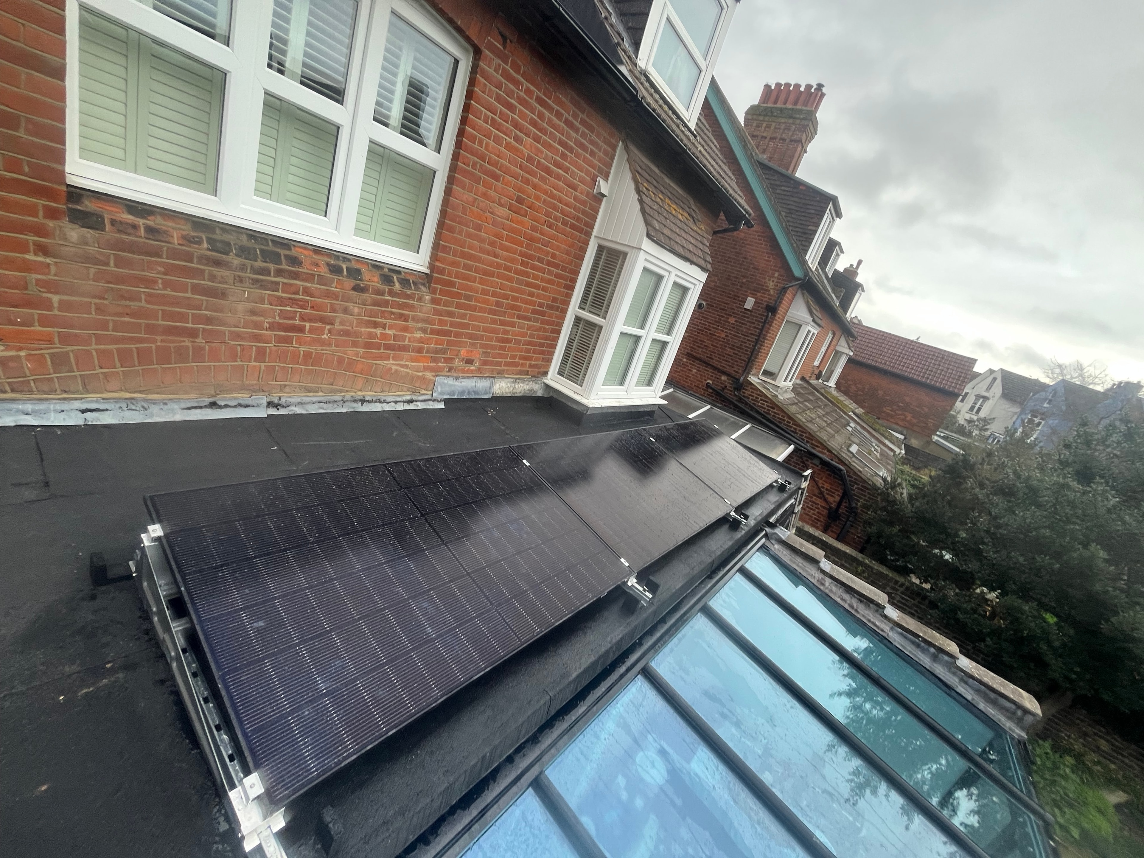 Solar panels beside conservatory roof